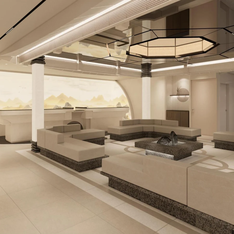 The waiting lounge at Kind Global Clinic Myeongdong: pale travertine floors, low cream banquette seating around a stone water feature, and a faceted paper pendant light.